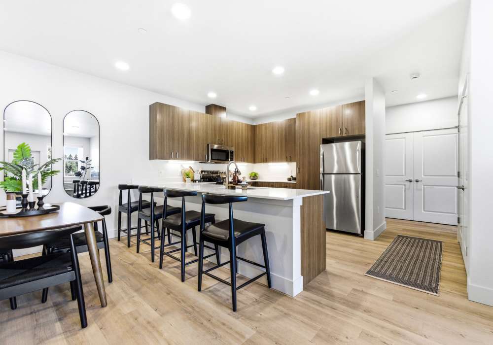 Brightly lit kitchen with stainless-steel appliances at The Heights at Happy Valley in Happy Valley, Oregon