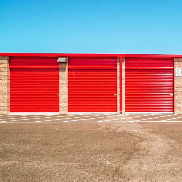 Outdoor drive-up storage units with red doors at StorQuest Self Storage in Fairfield, California