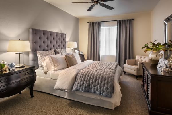 Well-decorated bedroom with ceiling fan in model home at San Paseo in Phoenix, Arizona