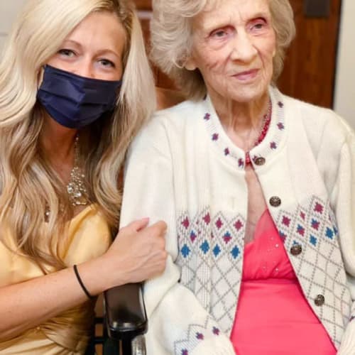A team member posing with a resident at Oxford Glen Memory Care at Owasso in Owasso, Oklahoma