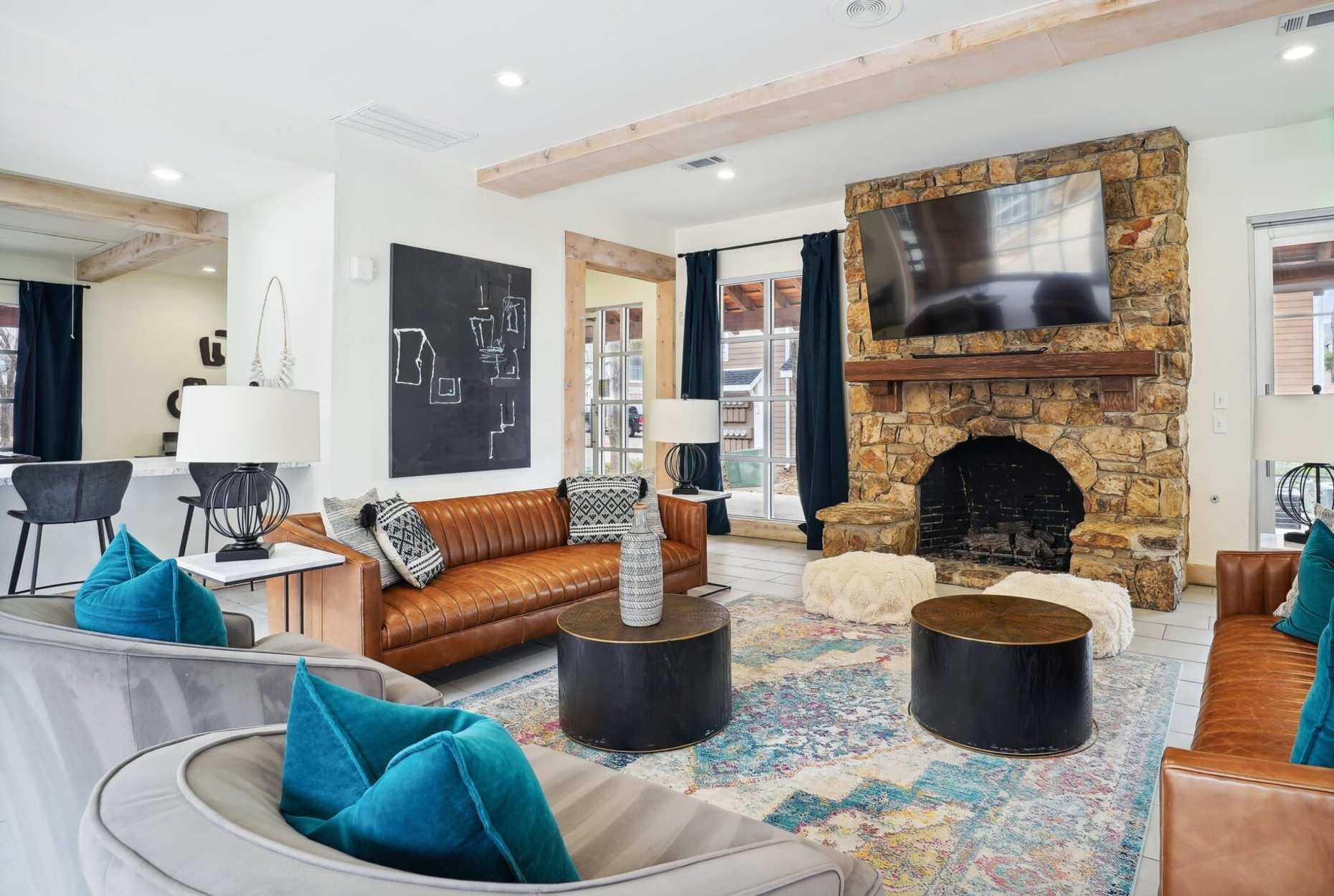 Luxury clubhouse with a couch, TV and a fireplace at Flatiron District at Austin Ranch, The Colony, Texas