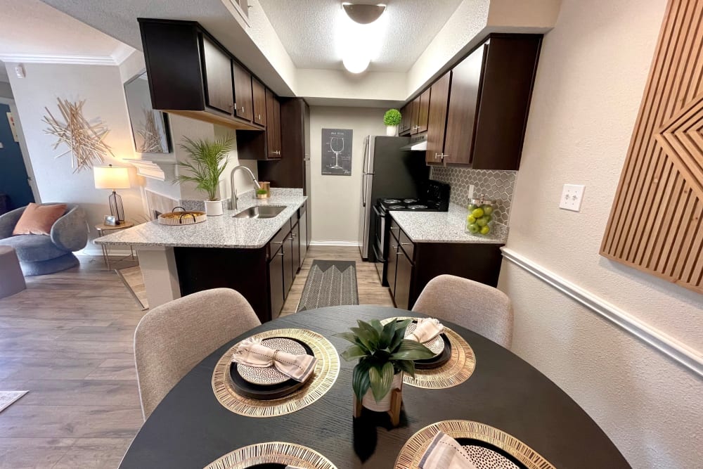 Dining nook and kitchen in a model apartment at The Abbey at Willowbrook in Houston, Texas