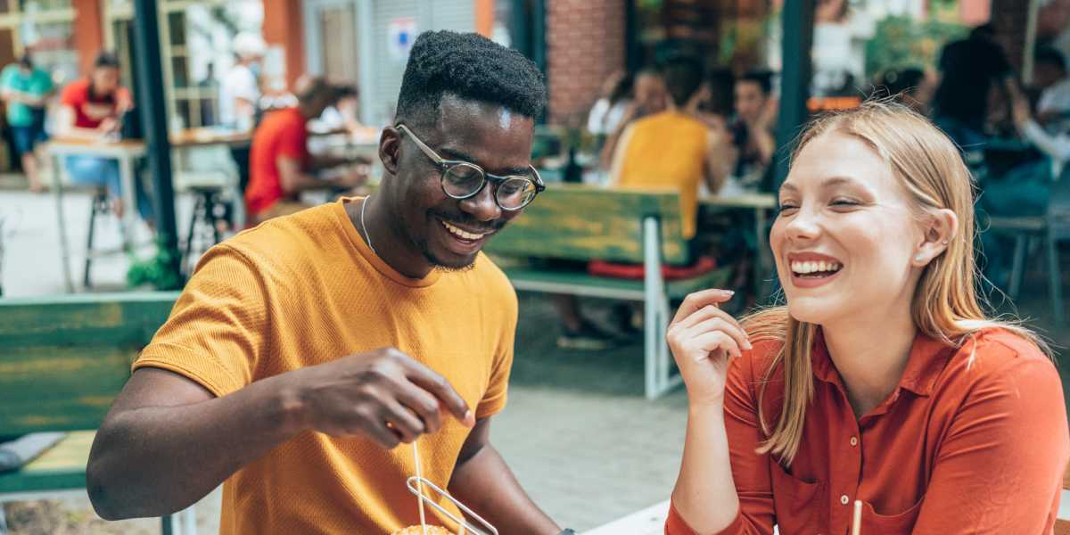 man and woman eating burgers and fries at outdoor restaurant at  Signal Hill in Manassas, Virginia
