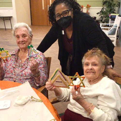 Team member with residents at Oxford Glen Memory Care at Carrollton in Carrollton, Texas