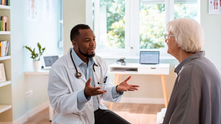 Doctor talking to a senior patient at an appointment 