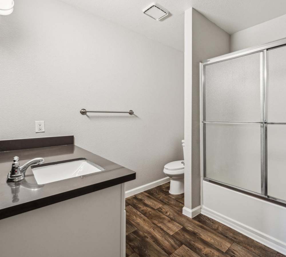 Bathroom with white cabinets and grey countertops