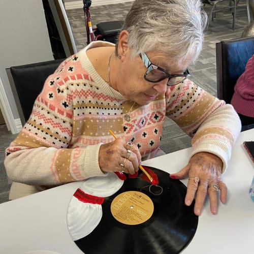 Resident having her nails done by a team member at Oxford Villa Active Senior Apartments in Wichita, Kansas