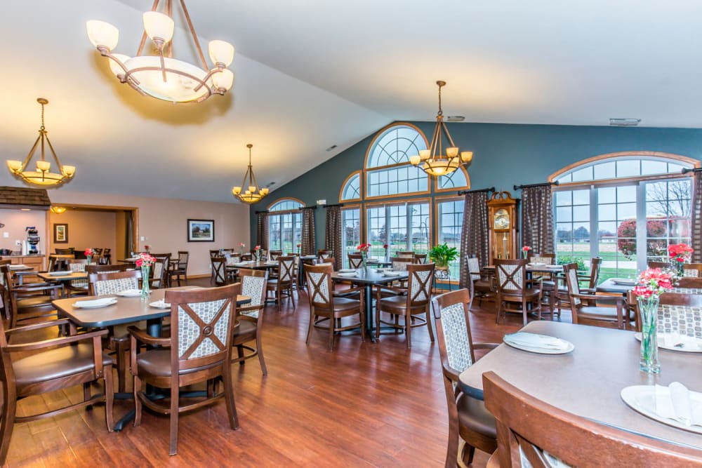 Elegant dining room with chandeliers at Brookstone Estates of Olney in Olney, Illinois