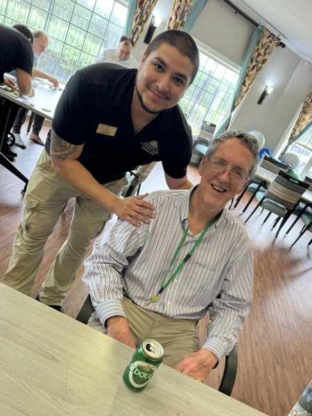 Resident and staff member sharing a smile at The Landing at Stone Oak in San Antonio, TX, during a fun and engaging community activity.