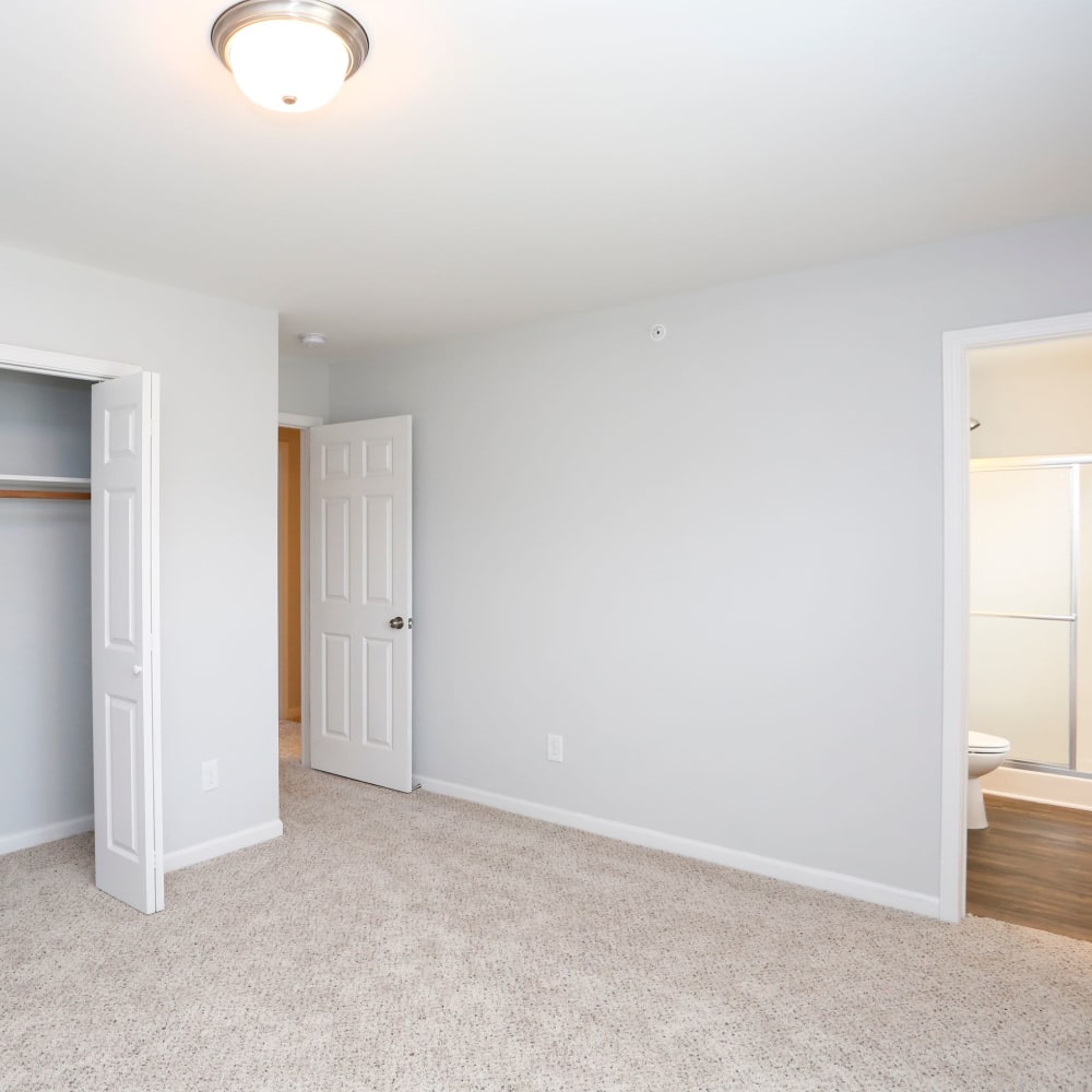 Bedroom with large closet and bathroom at Rippling Stream Townhomes in Durham, North Carolina