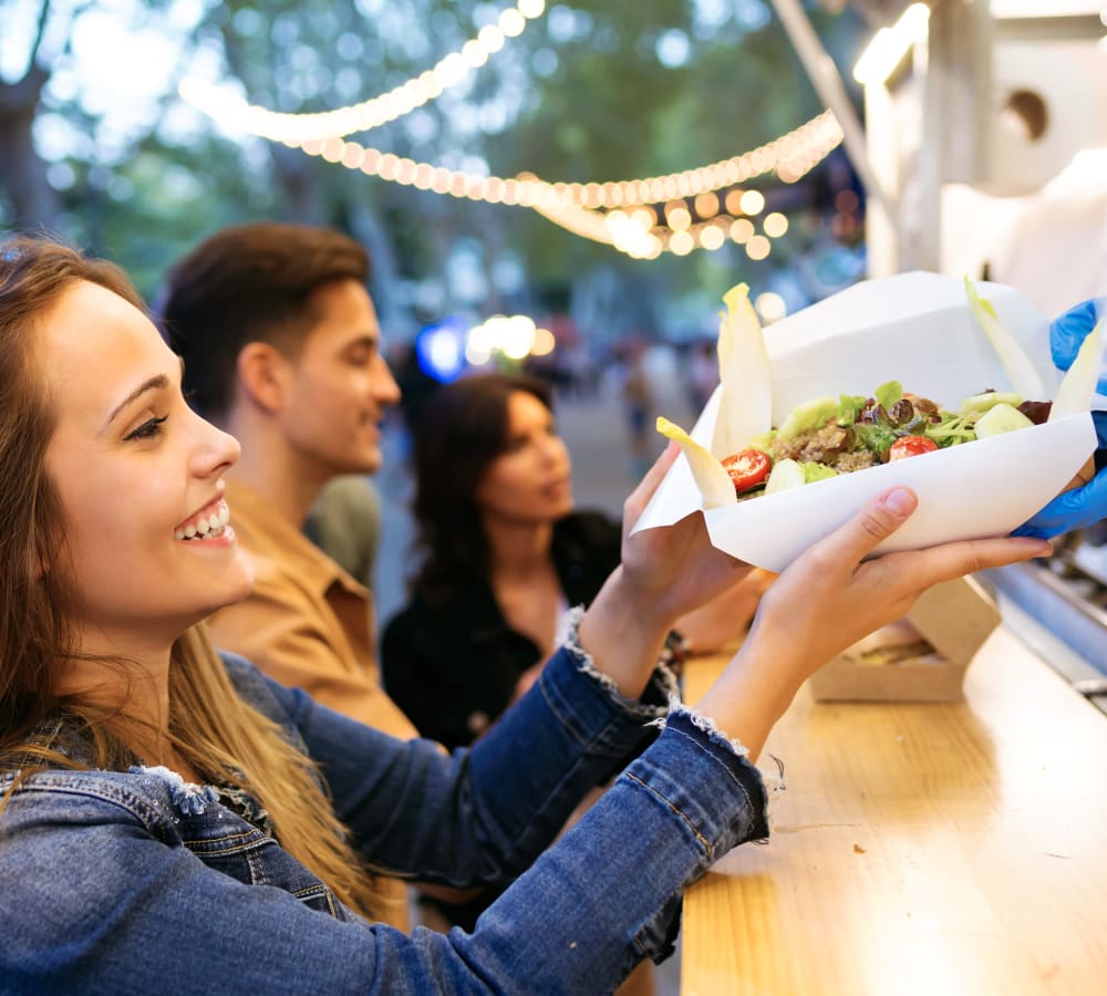 A woman grabbing food from a food truck near Gates at Jubilee in Daphne, Alabama