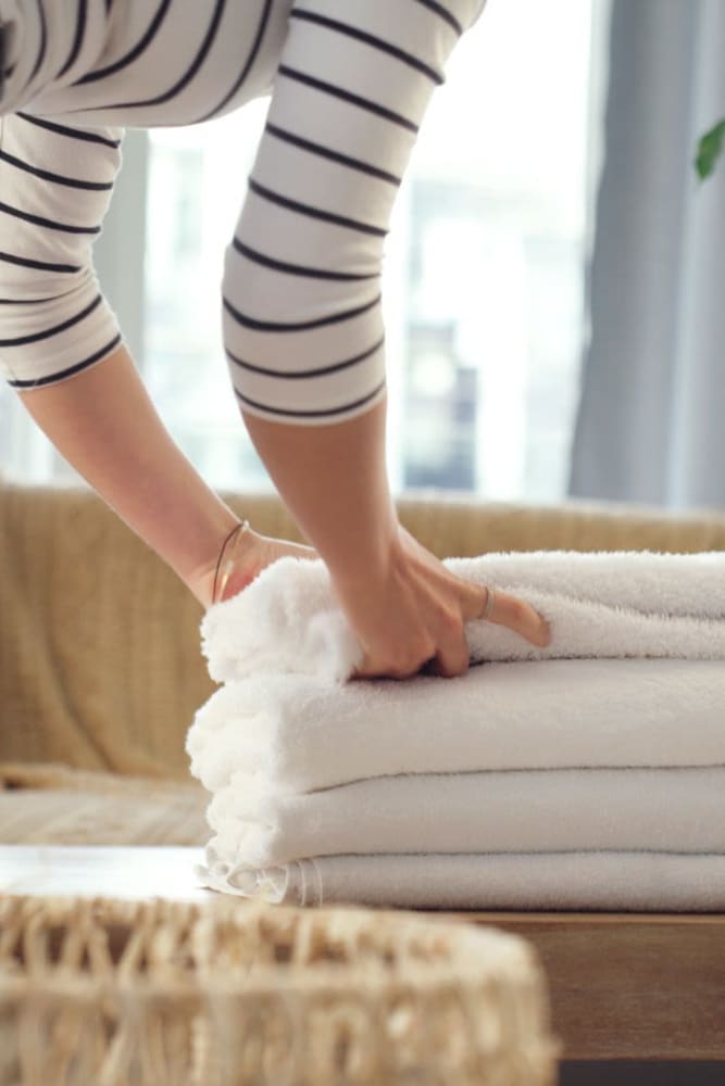 Resident folding towels at Kenneth Park Apartments in Carmichael, California