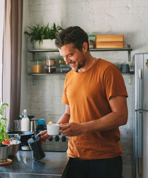 Man making himself some coffee at The Pointe at Warner Center in Woodland Hills, California