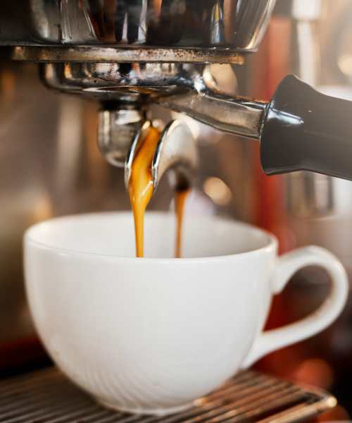 A coffee cup is being poured into an espresso machine at The Edison at Riverwood in Hermitage, Tennessee