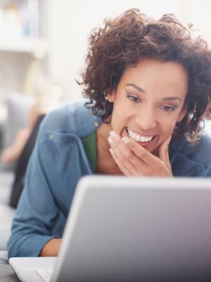 A woman checks her work email near The Artisan in San Diego, California