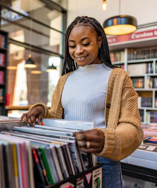 Woman flipping through records at a shop near LoHi Gold in Denver, Colorado