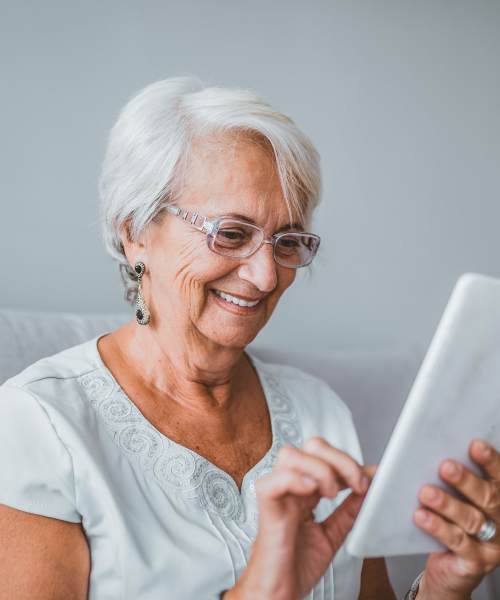 Residents enjoying her tablet at Lakeview Senior Living in Lakewood, Colorado