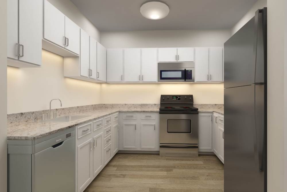 Kitchen with stainless-steel appliances and refrigerator at Harmony at Tucker Station in Louisville, Kentucky