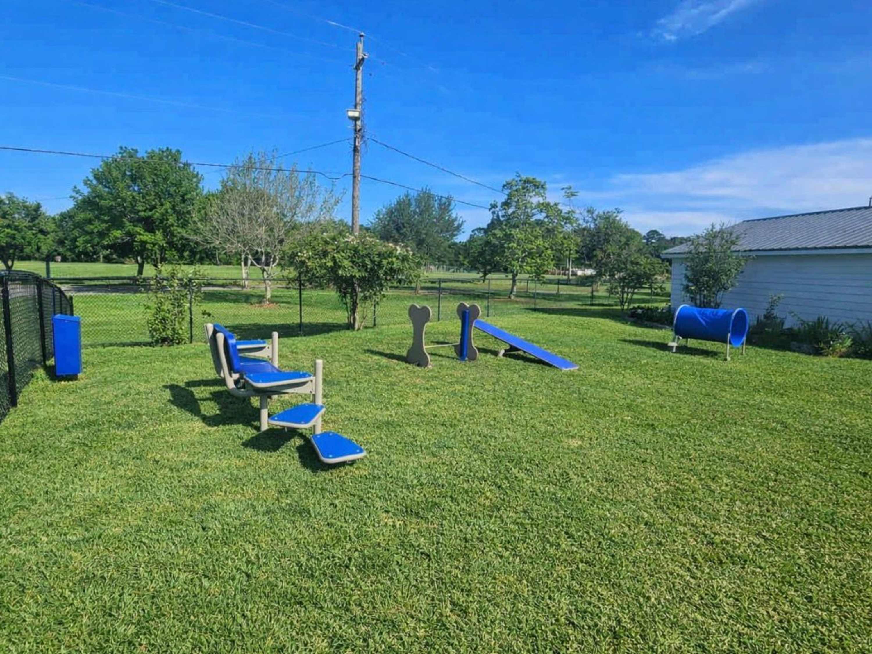 Apartment dog park with agility equipment at The Bayou District in Gulfport, Mississippi