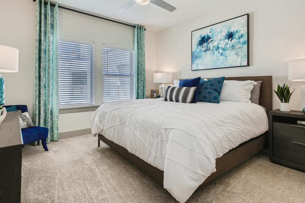 Furnished apartment bedroom with large window at Soba Apartments in Jacksonville, Florida