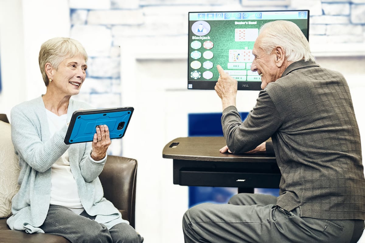 Senior adults engaging with technology at Landing at Watermere Frisco in Frisco, Texas