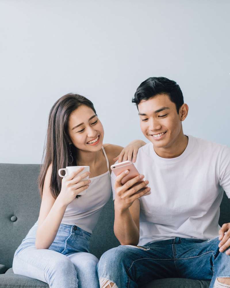Resident couple relaxing in their new home at The District in Asheville, North Carolina