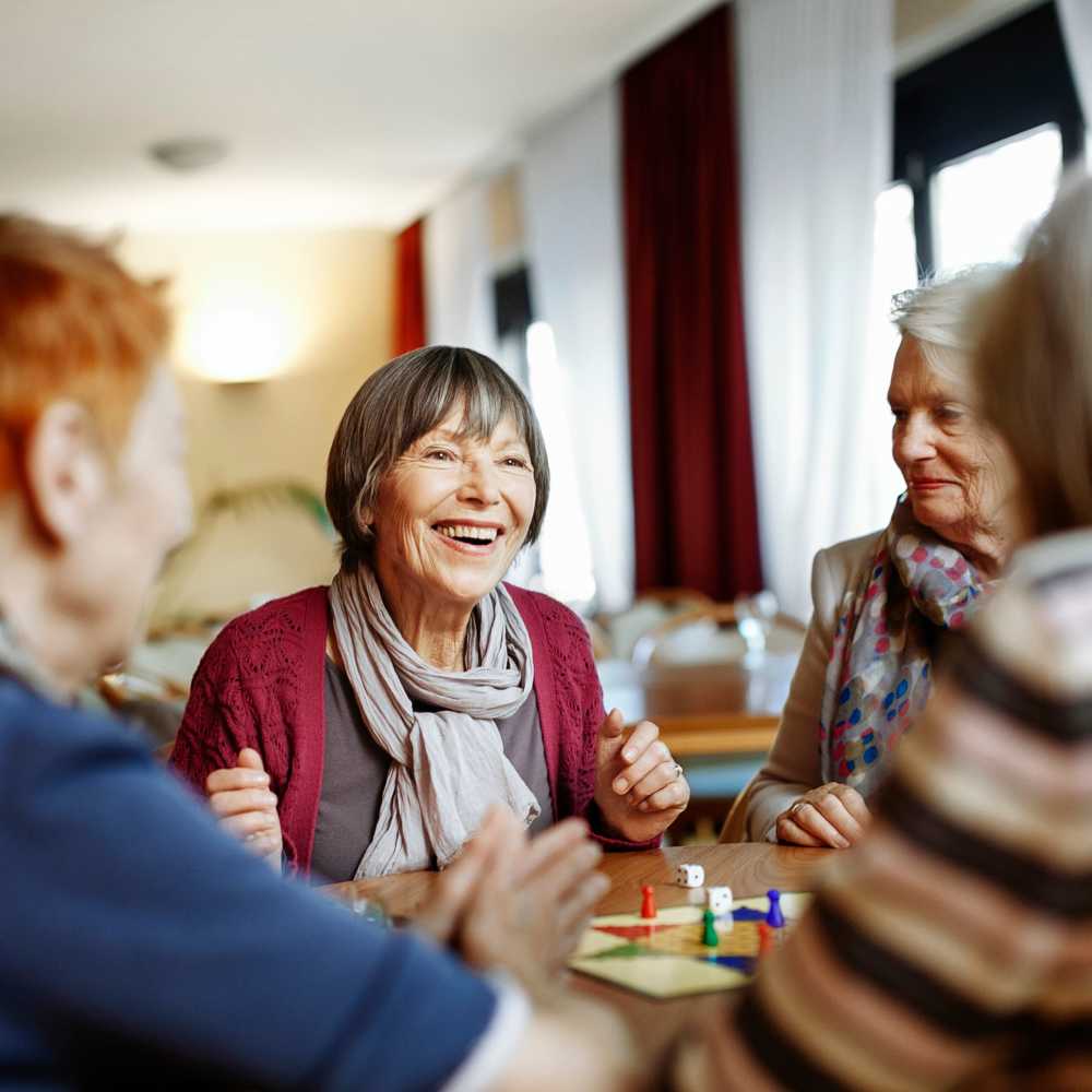 Women at a table enjoying a board game at Coral Wood Court in Reseda, California