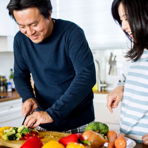 A happy couple cooking at Osprey Point in Virginia Beach, Virginia