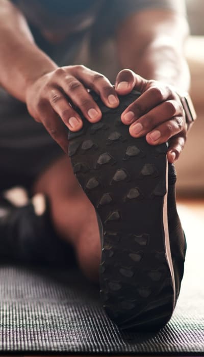 Resident stretching before a run at Auro Crossing in Austin, Texas