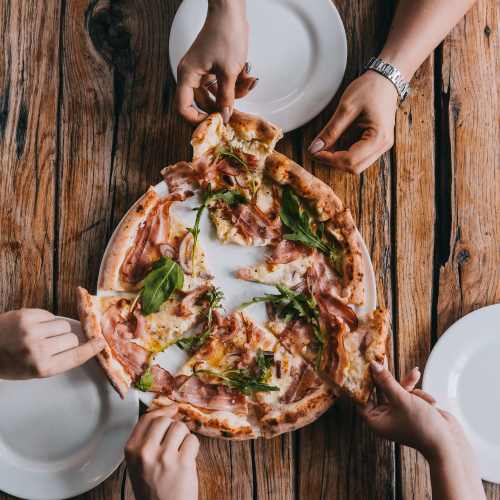 A group of friends sharing a pizza near Copper Stone in Lafayette, Colorado