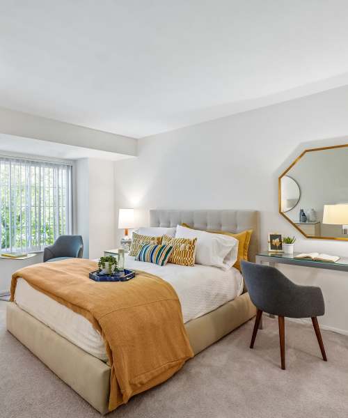 Model bedroom with a desk by the window at Saddle Creek Apartments in Novi, Michigan