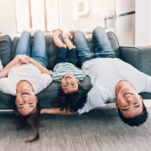 A family sitting upside down on a couch at Woodlake in Lakeside, California