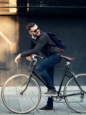 A man biking to work from his apartment at Harborside Marina Bay Apartments in Marina del Rey, California