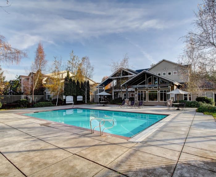 Inviting swimming pool on a beautiful day at River Trail Apartments in Puyallup, Washington