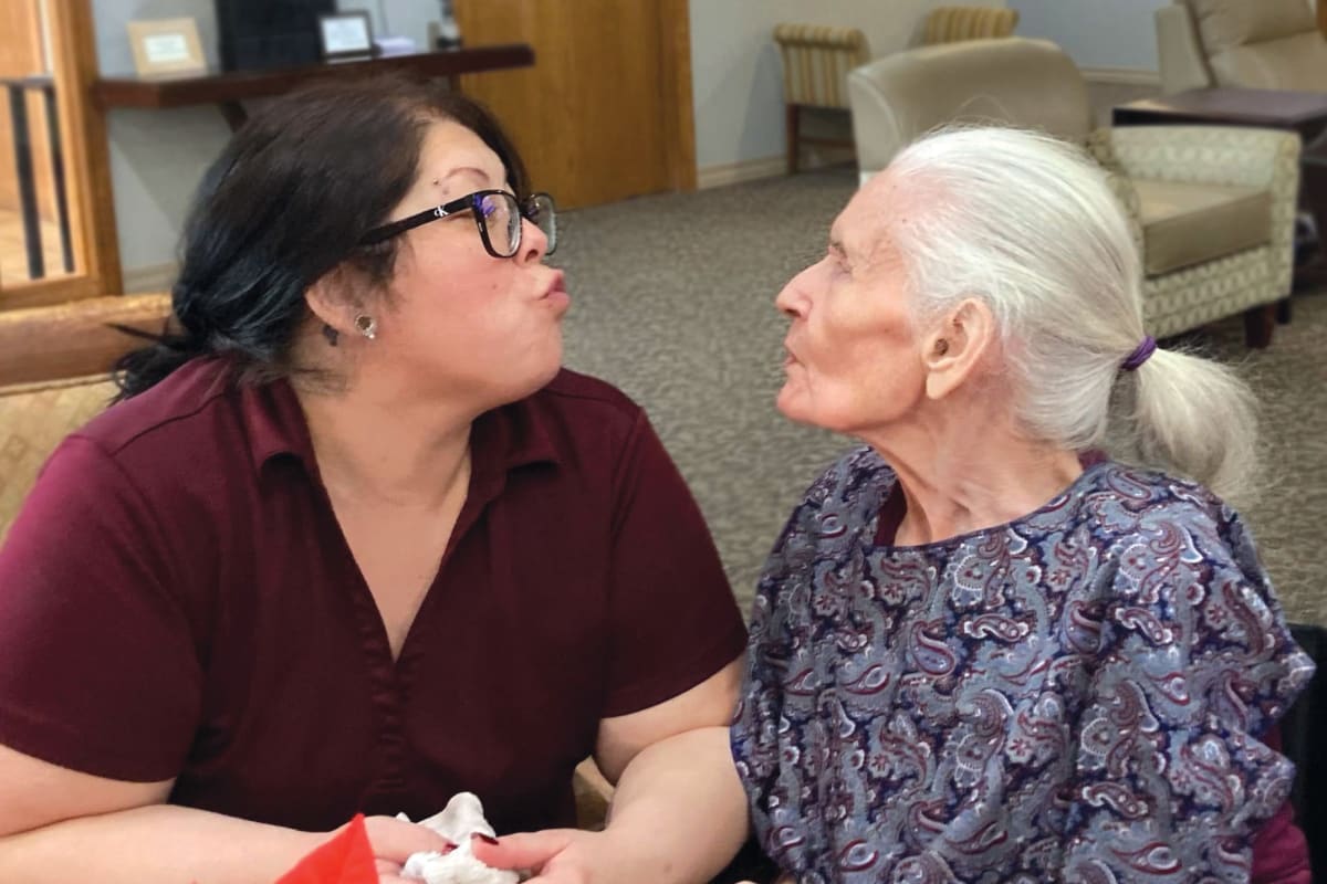 A resident and a caregiver having a nice conversation at Saddlebrook Oxford Memory Care in Frisco, Texas