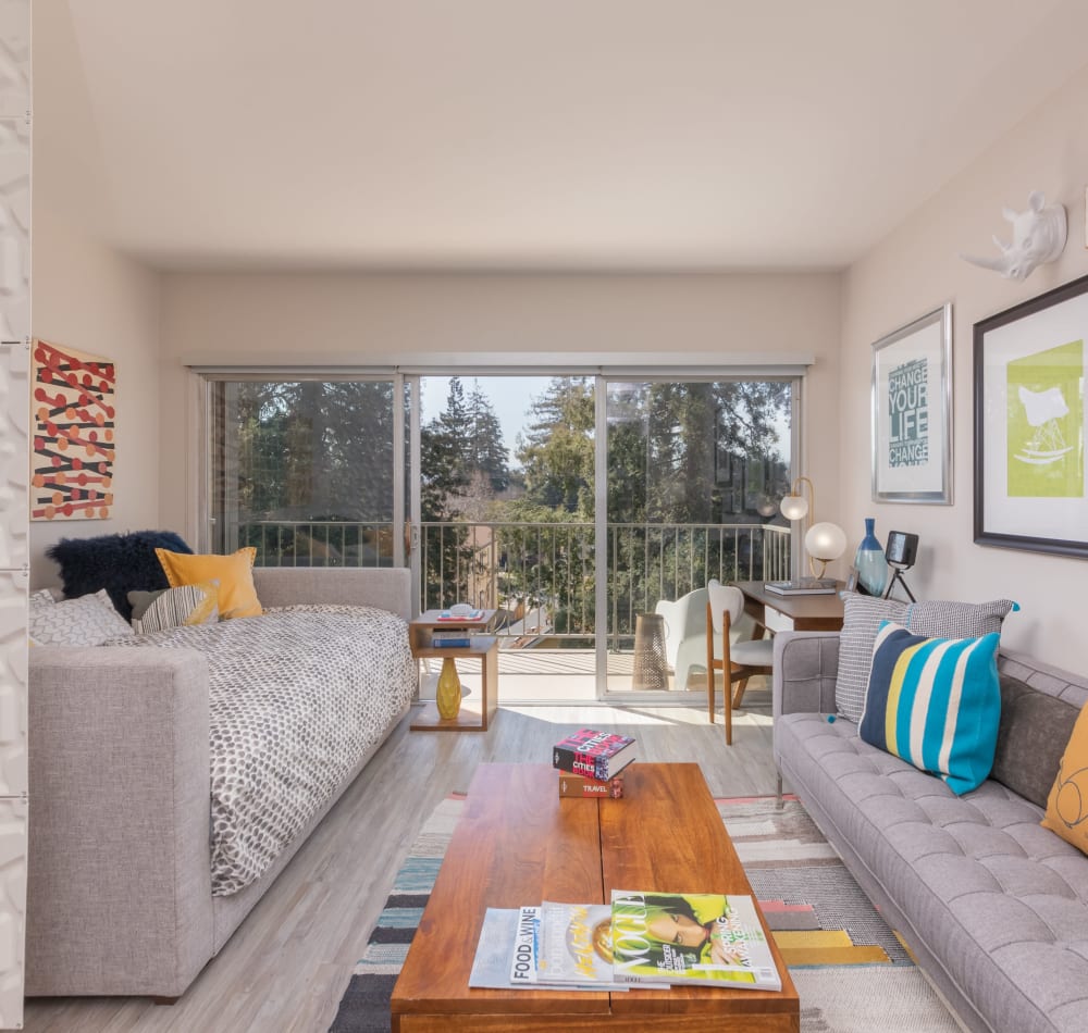 Living area looking out on the spacious private balcony outside a model home at Mia in Palo Alto, California