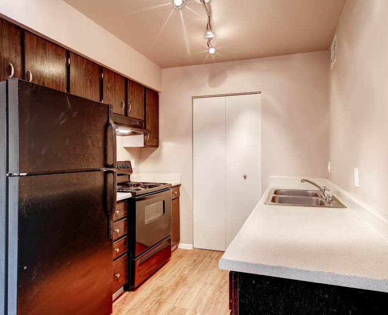 Model kitchen with dark cabinets at Arvada Village Apartment Homes in Arvada, Colorado