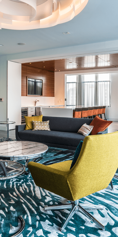 Resident lounge with bar seating and floor-to-ceiling windows at Solaire 7077 Woodmont in Bethesda, Maryland