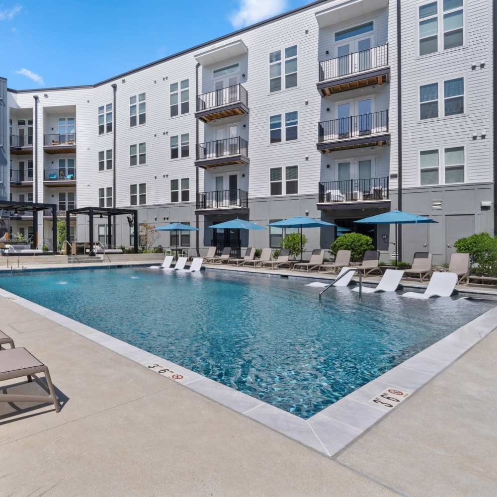 Pool and deck with lounge beds covered by canopies at The Guild in Richmond, Virginia