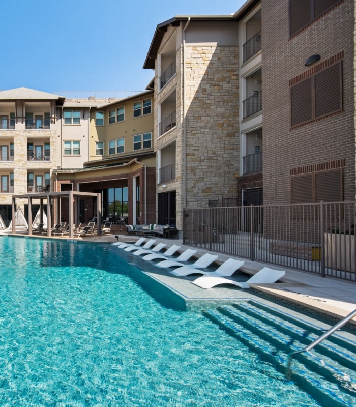 Sparkling swimming pool with sundeck at Discovery Park in Denton, Texas