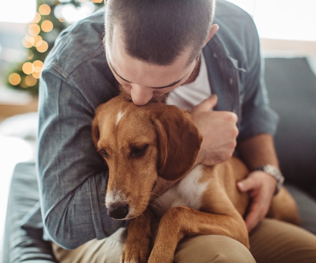 Resident holding his dog at Fox Run Apartments in Wichita, Kansas
