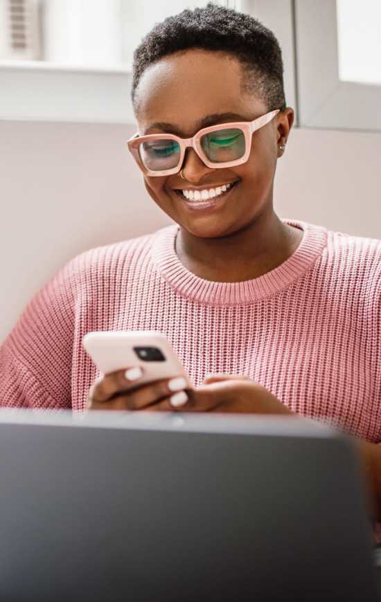 Resident using her laptop at The Den in Columbia, Missouri