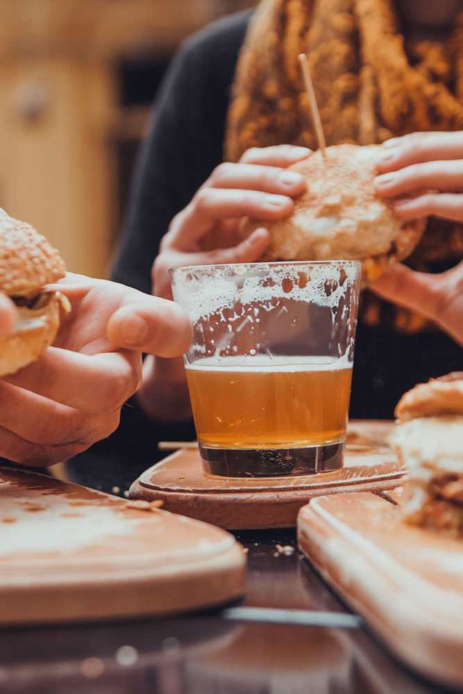 Resident eating and drinks in bar near   Grandview Garden Apartments in Florissant, Missouri