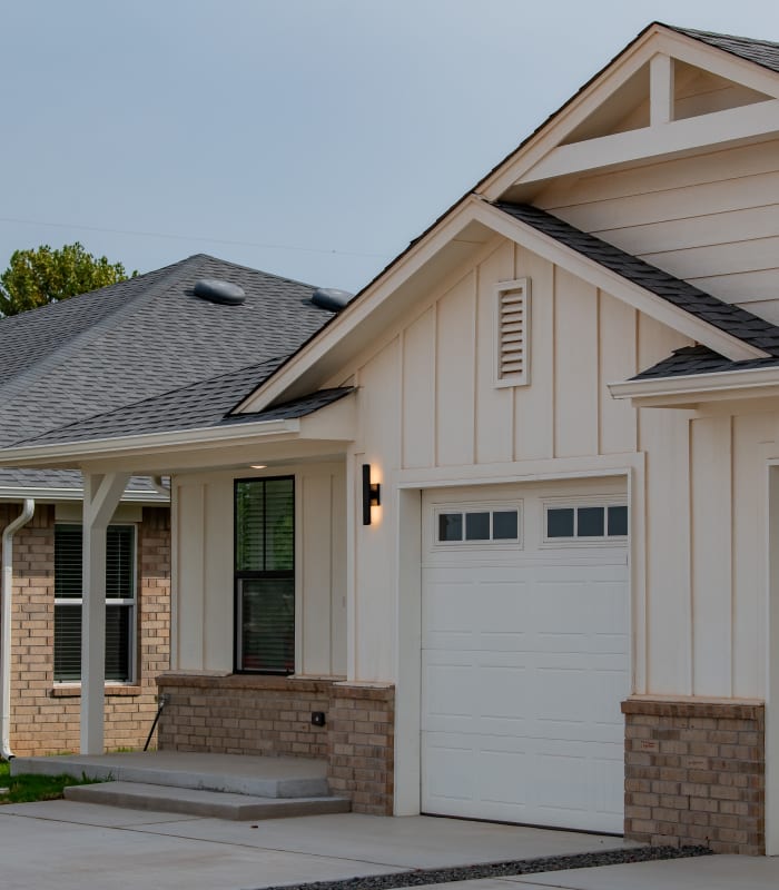 Beautiful exterior with small porch and garage at Chisholm Pointe in Oklahoma City, Oklahoma