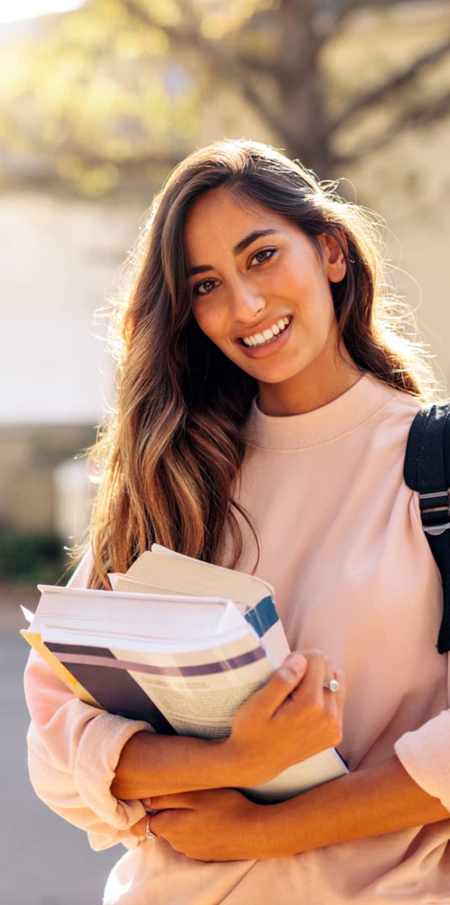 Student carrying her books on campus near West 22 in Kennesaw, Georgia
