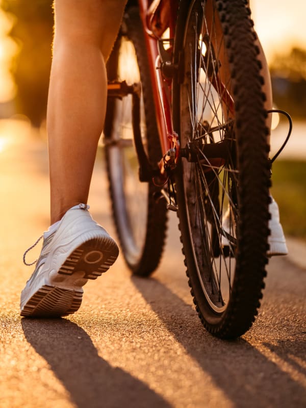 Resident riding their bike near Tuscany Pointe at Tampa Apartment Homes in Tampa, Florida