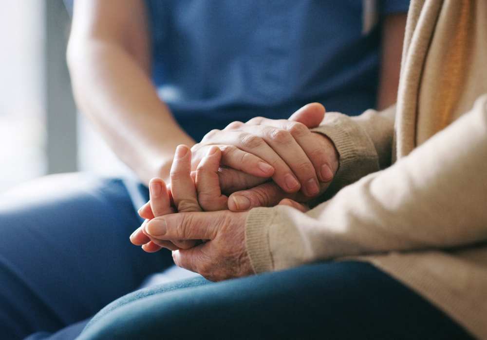 Caretaker comforting resident at Clearwater Beaverton in Beaverton, Oregon