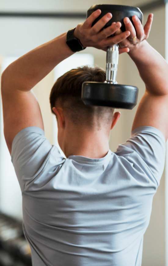 Student lifting weights at Brookside Downtown in Columbia, Missouri