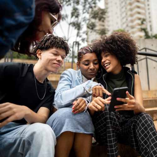 Friends sitting outside near Ventura Park Plaza Apartments in Portland, Oregon