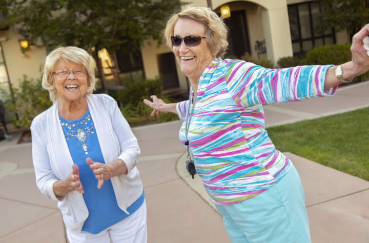 Two residents dance in the courtyard.